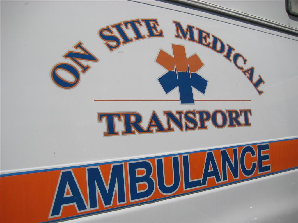 On Site Medical Transport Ambulance Orange And Blue Graphics
